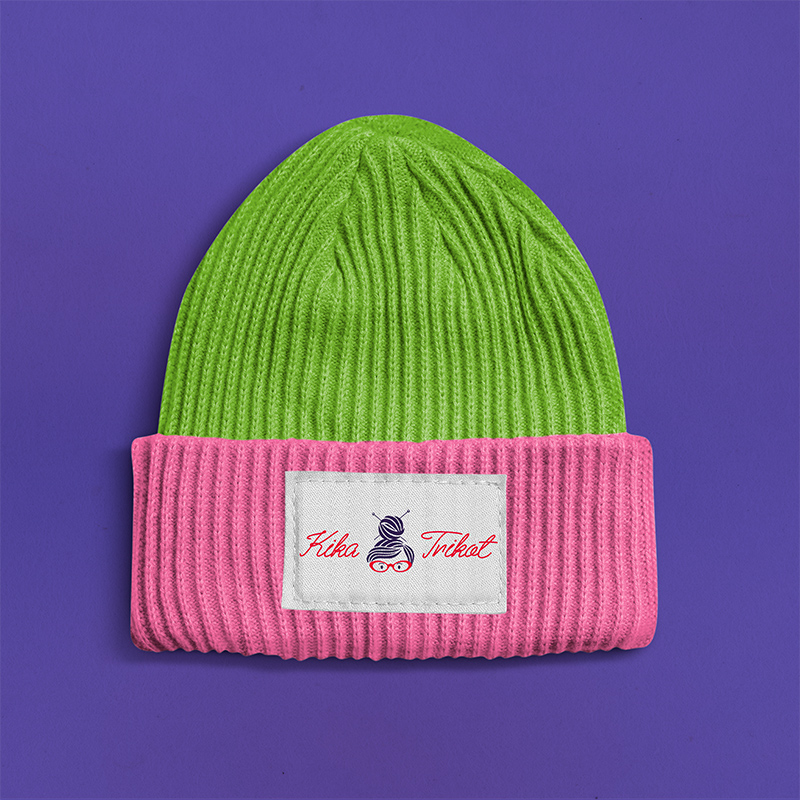 green and pink beanie with logo tag